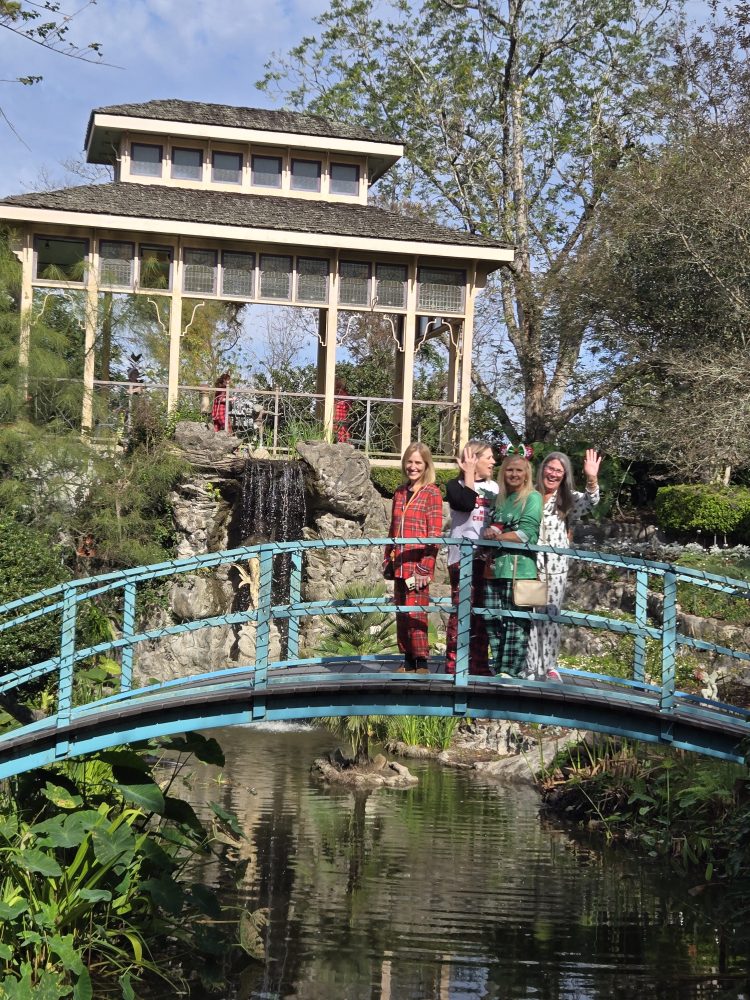 a group of people standing in front of a bridge