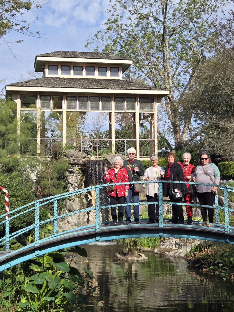 a group of people standing on a bridge