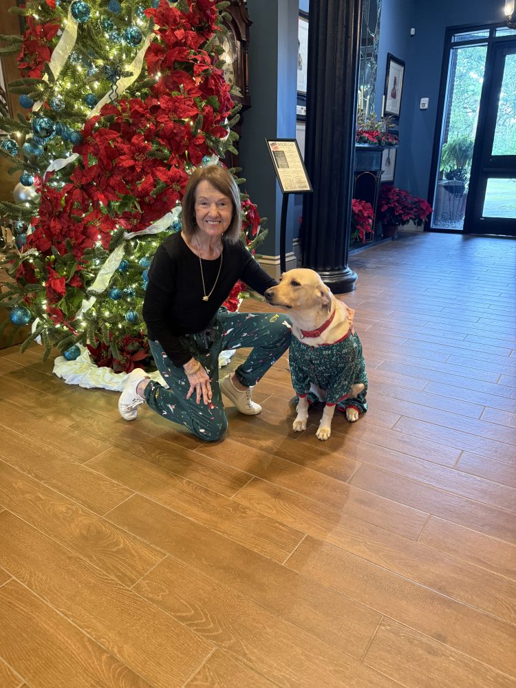 a person standing next to a christmas tree