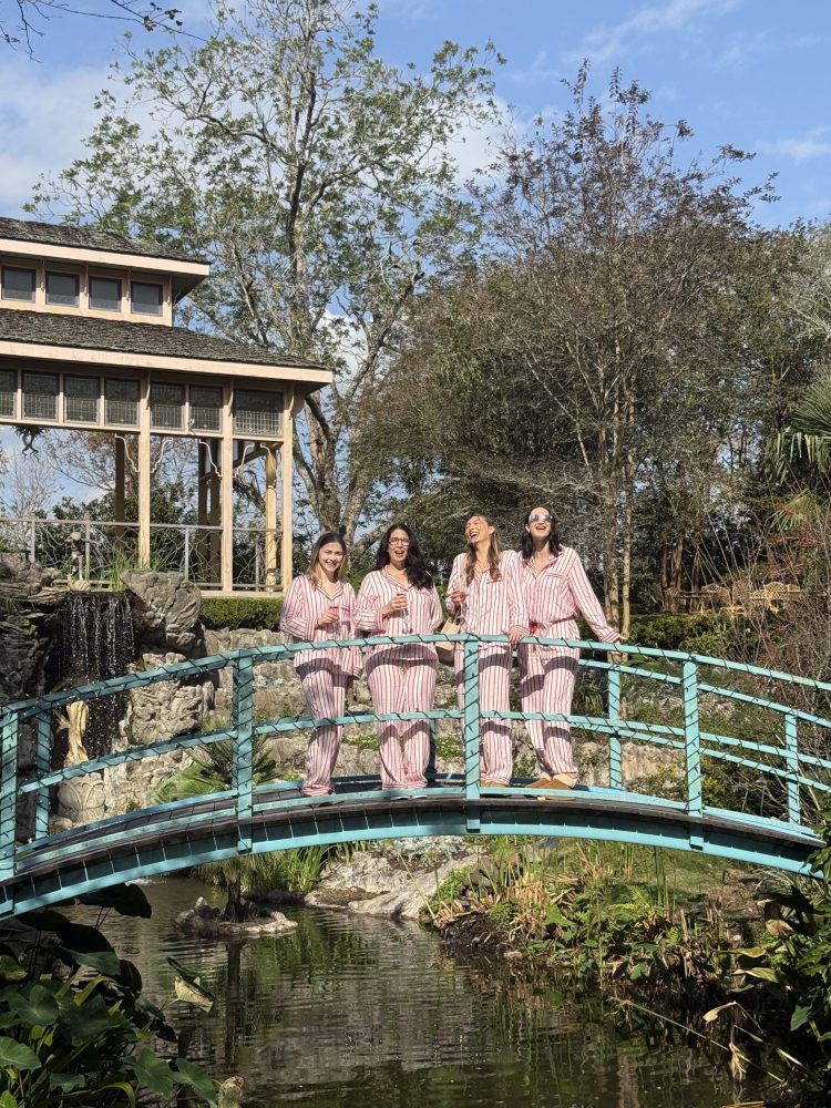 a group of people standing in front of a bridge