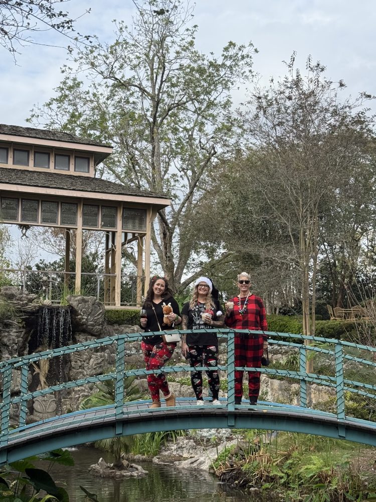 a group of people on a train track with trees in the background