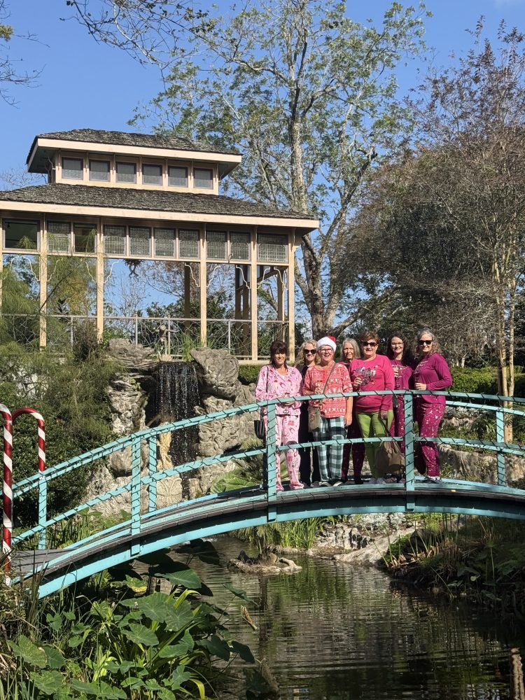 a group of people standing in a garden